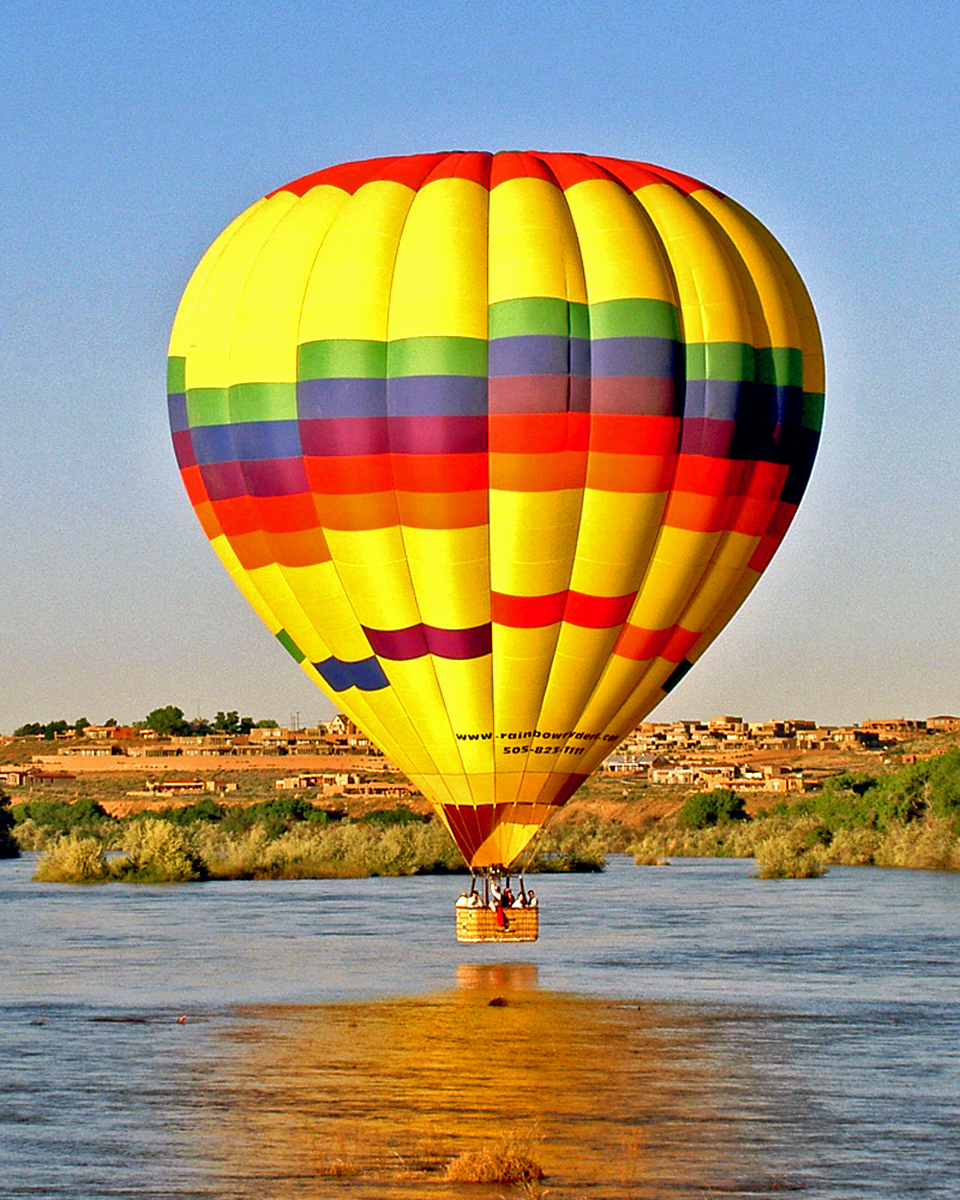 hot air balloon touching down on the Rio Grande, Albuquerque, New Mexico