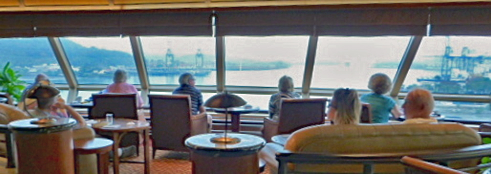 passengers in the Commodore Club aboard Cunard's Queen Elizabeth in the Panama Canal