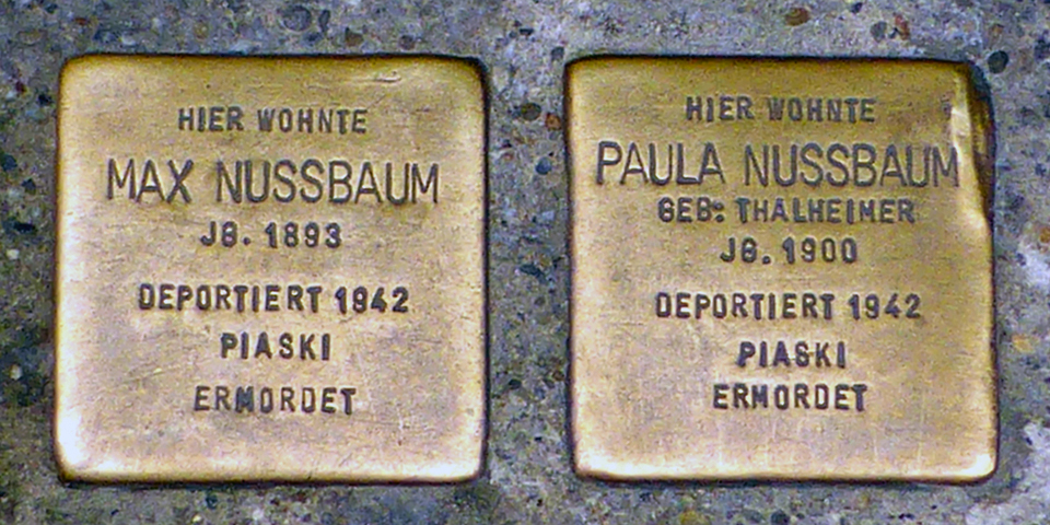 Plaques in sidewalks denoting former homes of Jewish people who were victims of the Holocost
