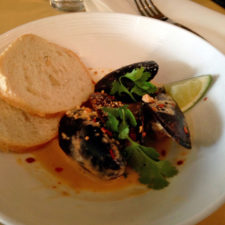 Mussels with curry, coconut, cashew, shallot, red chili, toast