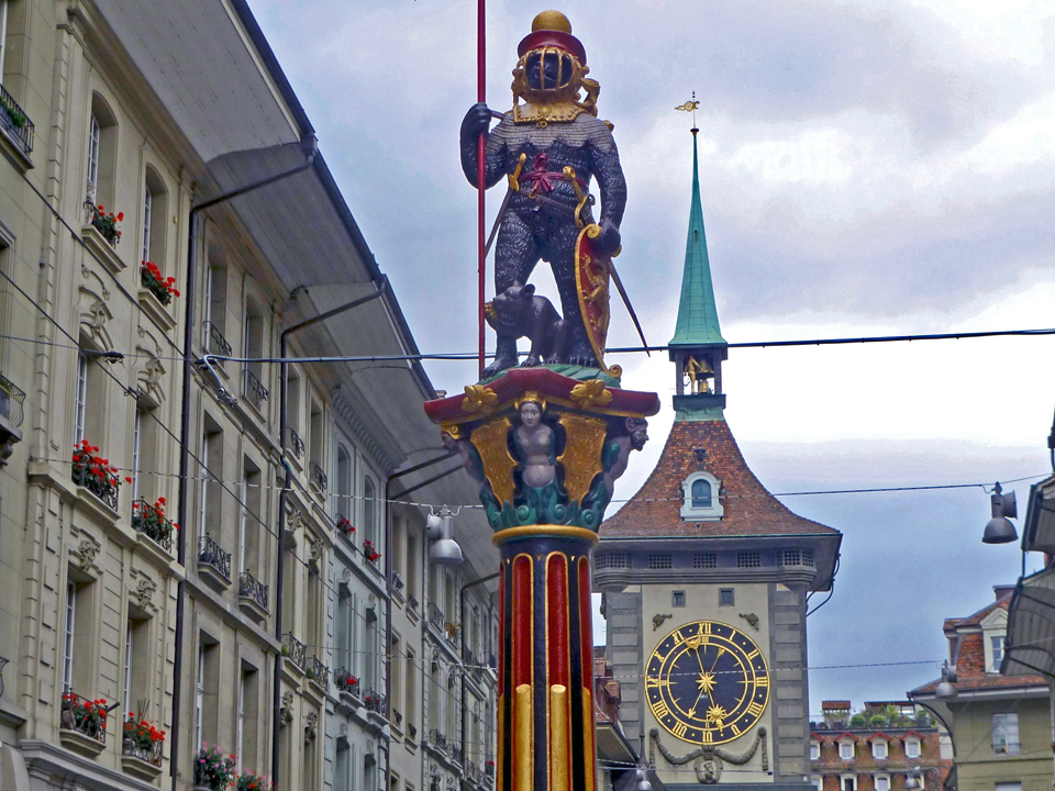 zahringerbrunne, the bear in full armor, and the medieval clock tower on Kramgasse, Bern, Switzerland