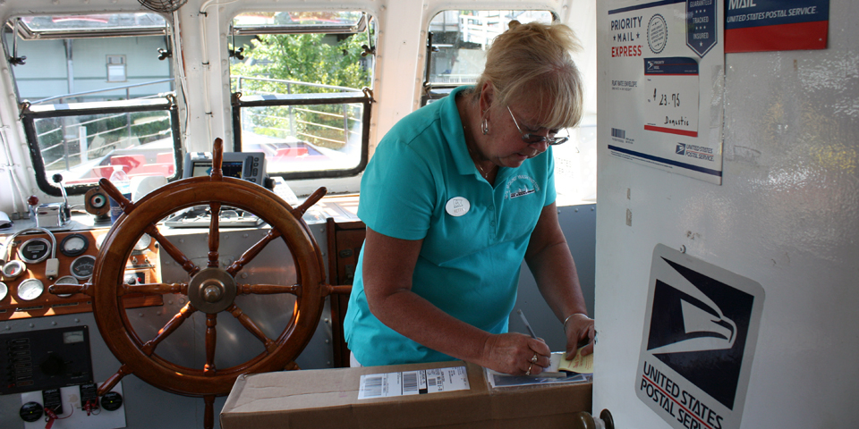 The postmistress in the mail boat M/V Sophie C.