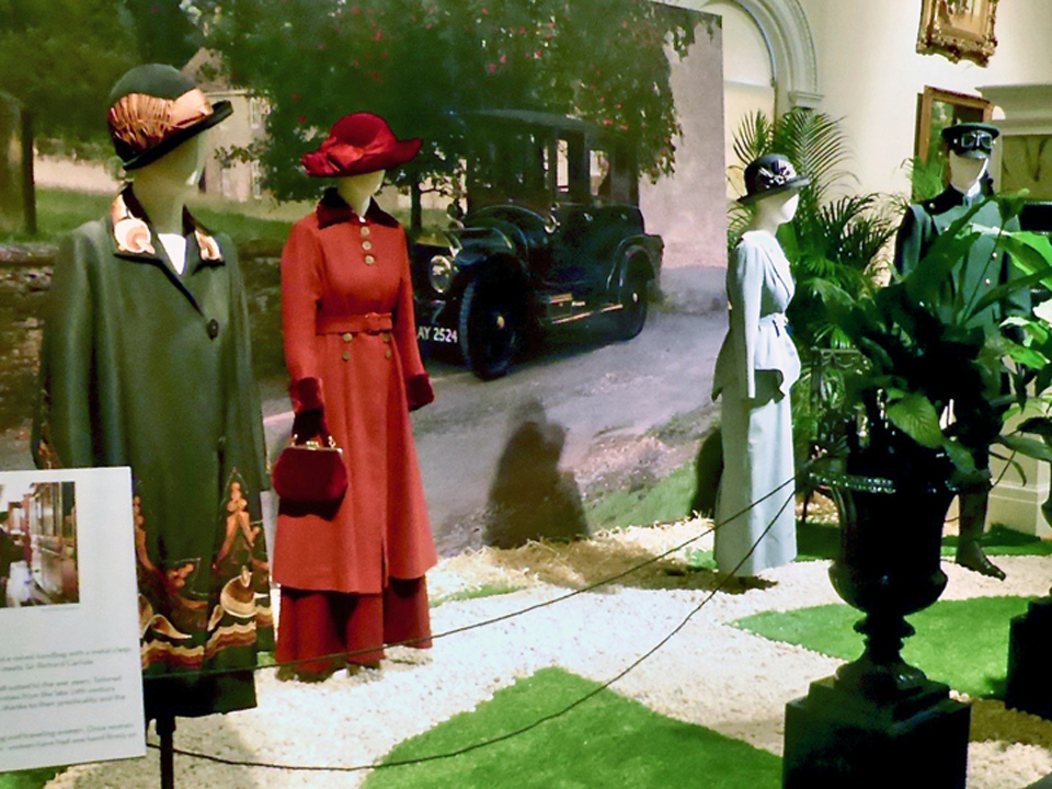 Lady Edith's Arts and Crafts style coat, Lady Mary’s red wool coat with velvet trim, Lady Sybil's tailored suit, and the chauffeur costume, Lightner Museum, St. Augustine, FL