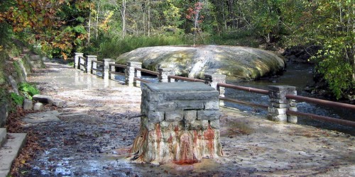 Mineral deposits from “The Geyser” spouter in Saratoga Springs has formed a mound, and debris that falls on it quickly becomes fossilized.