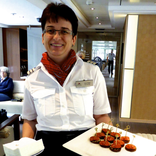 Hotel Manager Doris with canapés of Hungarian sausages.