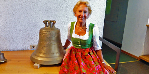 Elisabeth Grassmayr with a bell decorated with her family tree at the Grassmayr Bell Foundry, Innsbruck, Austria