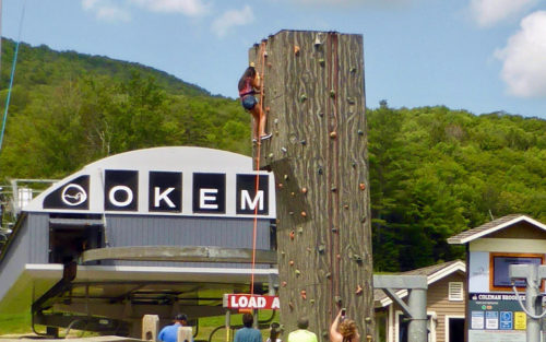 Rock climbing wall at the Bungee jump on a trampoline at the Adventure Zone of Okemo Mountain Resort
